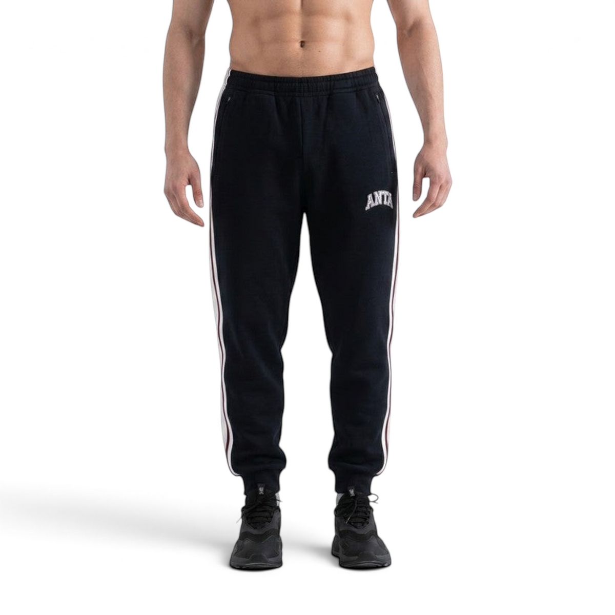 FRG ANTA black knit track pants for men with tapered fit, side stripes, and white logo detail on a model