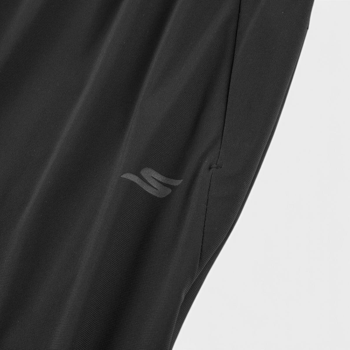 FRG black woven pants featuring a subtle tonal logo detail and side pocket construction