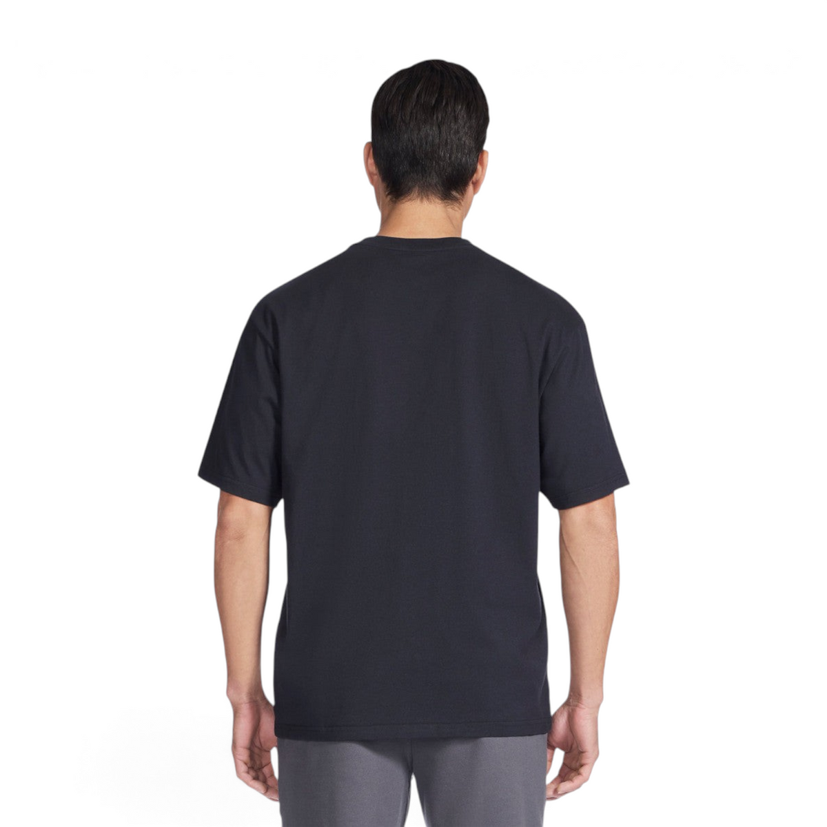 Back view of a man wearing a plain black Skechers JERSEY MAX SHORT SLEEVE t-shirt against a white background