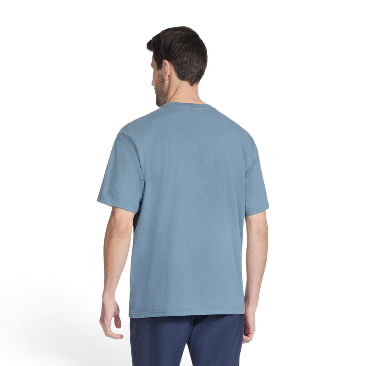 Back view of a man wearing a blue FRG SKECH-JERSEY MAX short sleeve t-shirt with a relaxed fit