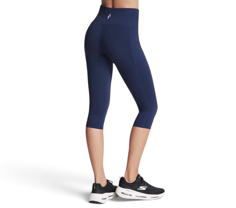 FRG Skechers women's navy blue high-rise knit capri leggings with side pockets worn with black athletic sneakers