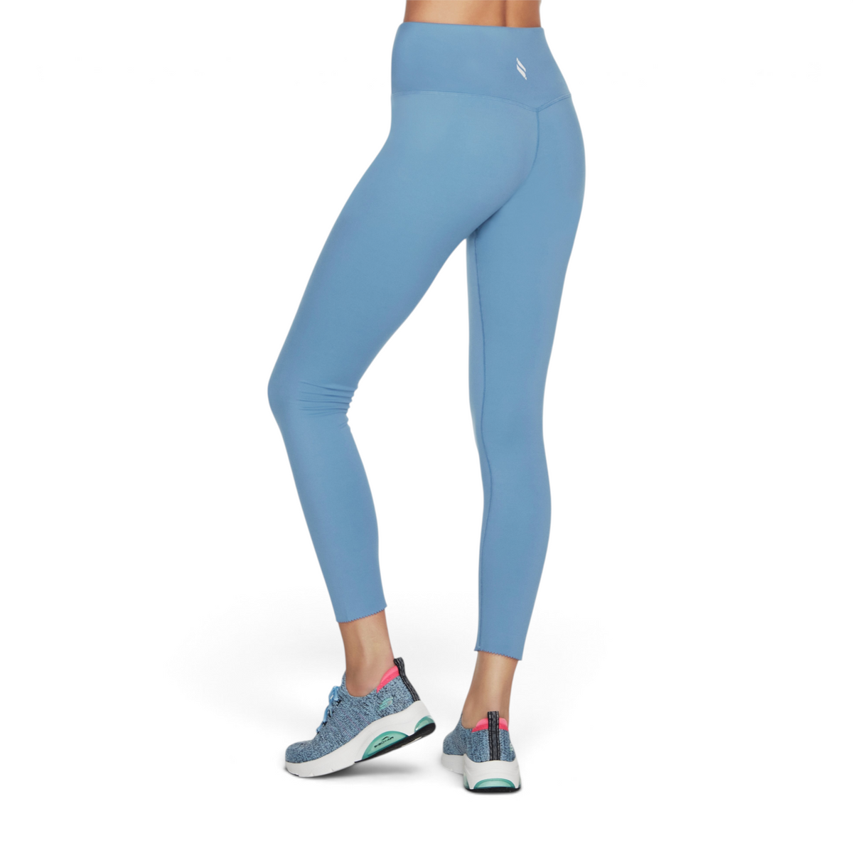 FRG blue high-waisted leggings with a scalloped hem detail worn by a model from a side view