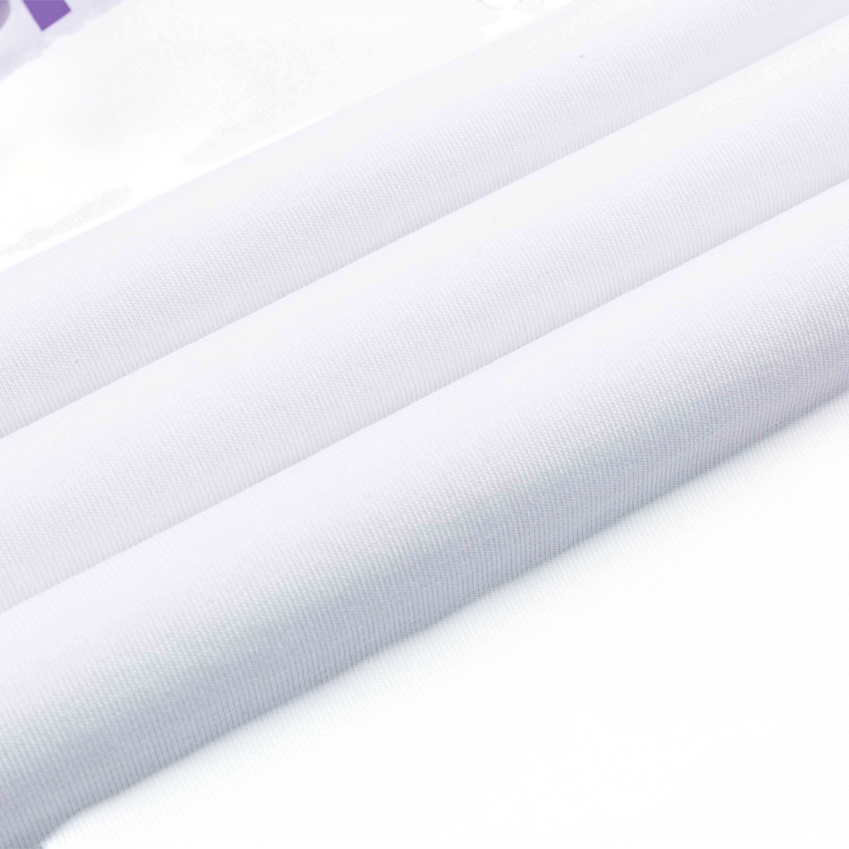 Close-up of smooth white fabric texture from a FRG SS TEE showing clean folds and high-quality material