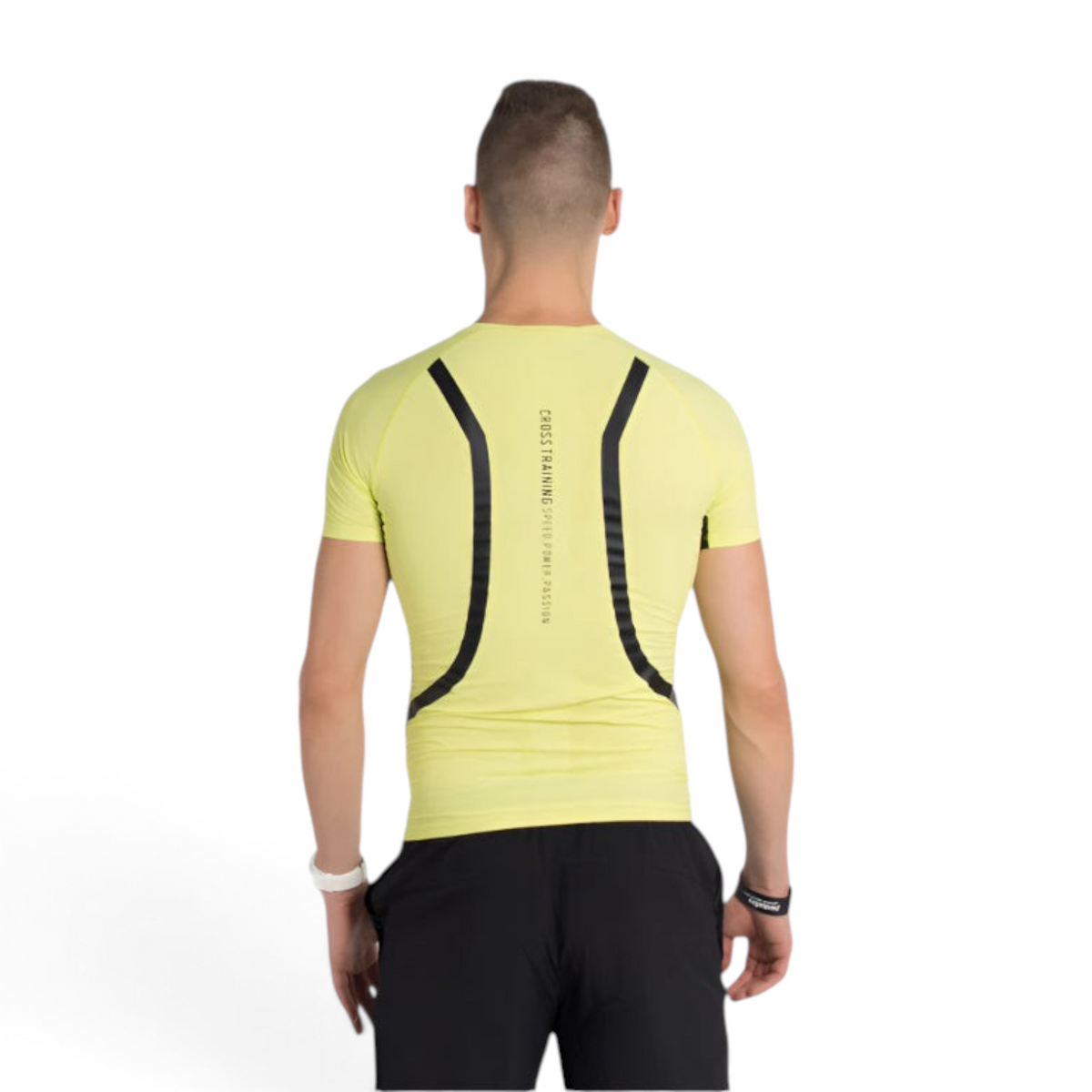 Back view of a man wearing a FRG tight-fit neon yellow short sleeve training top with black graphic details.