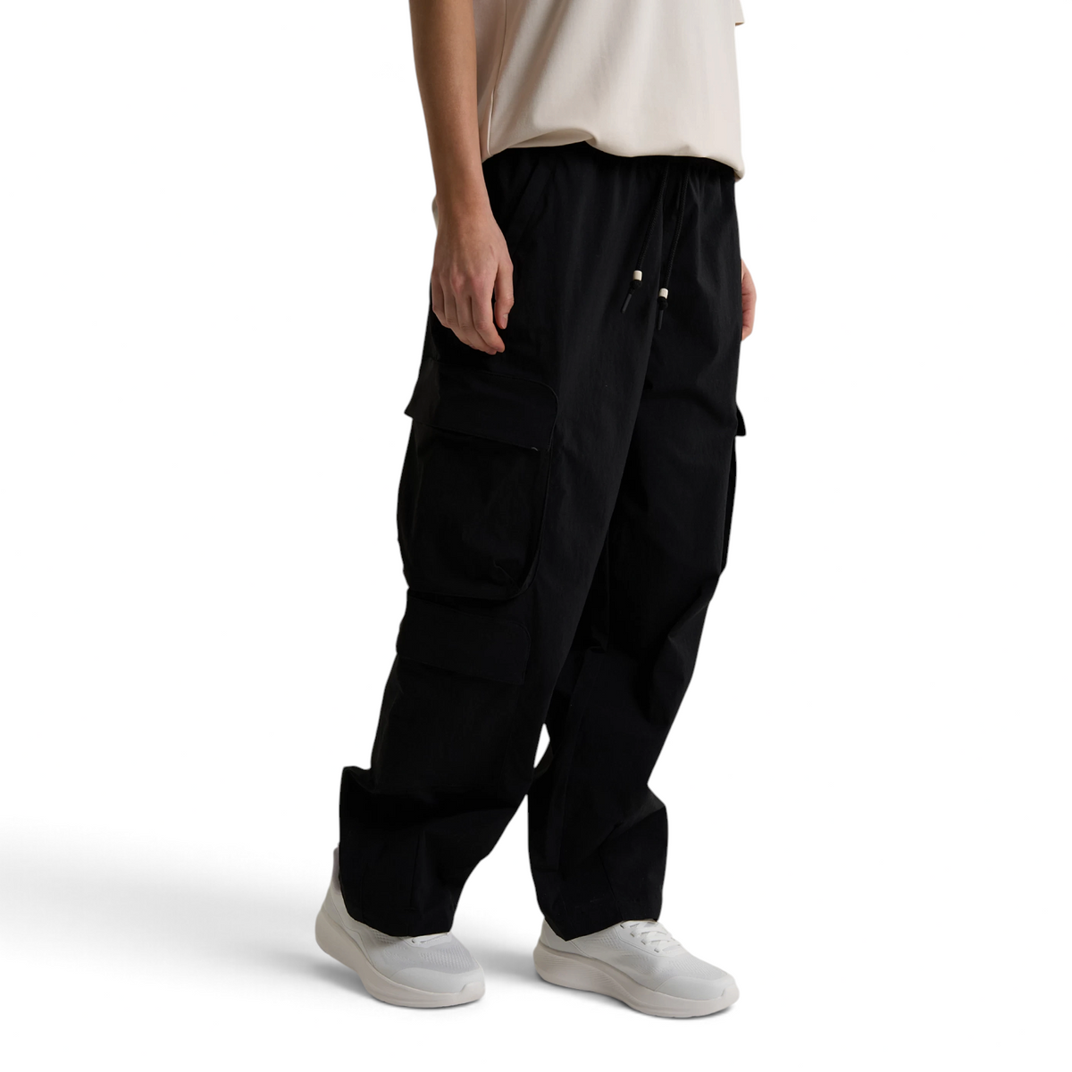 FRG ANTA black woven casual cargo pants with side pockets worn by a model with white sneakers