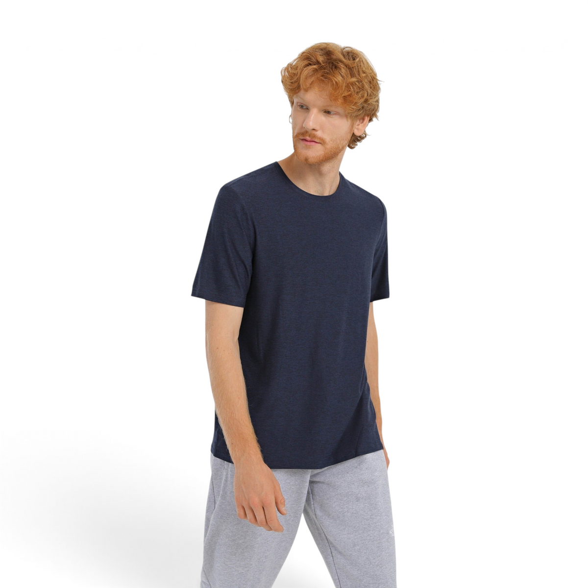 FRG GODRI ALL DAY TEE OPM in navy blue worn by a red-haired man against a white background