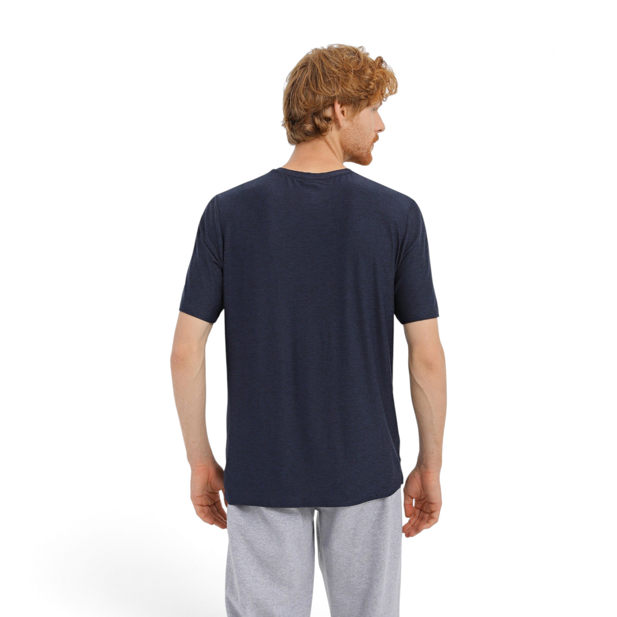 Back view of a man wearing a navy blue FRG GODRI ALL DAY TEE OPM with a comfortable fit against a white background.