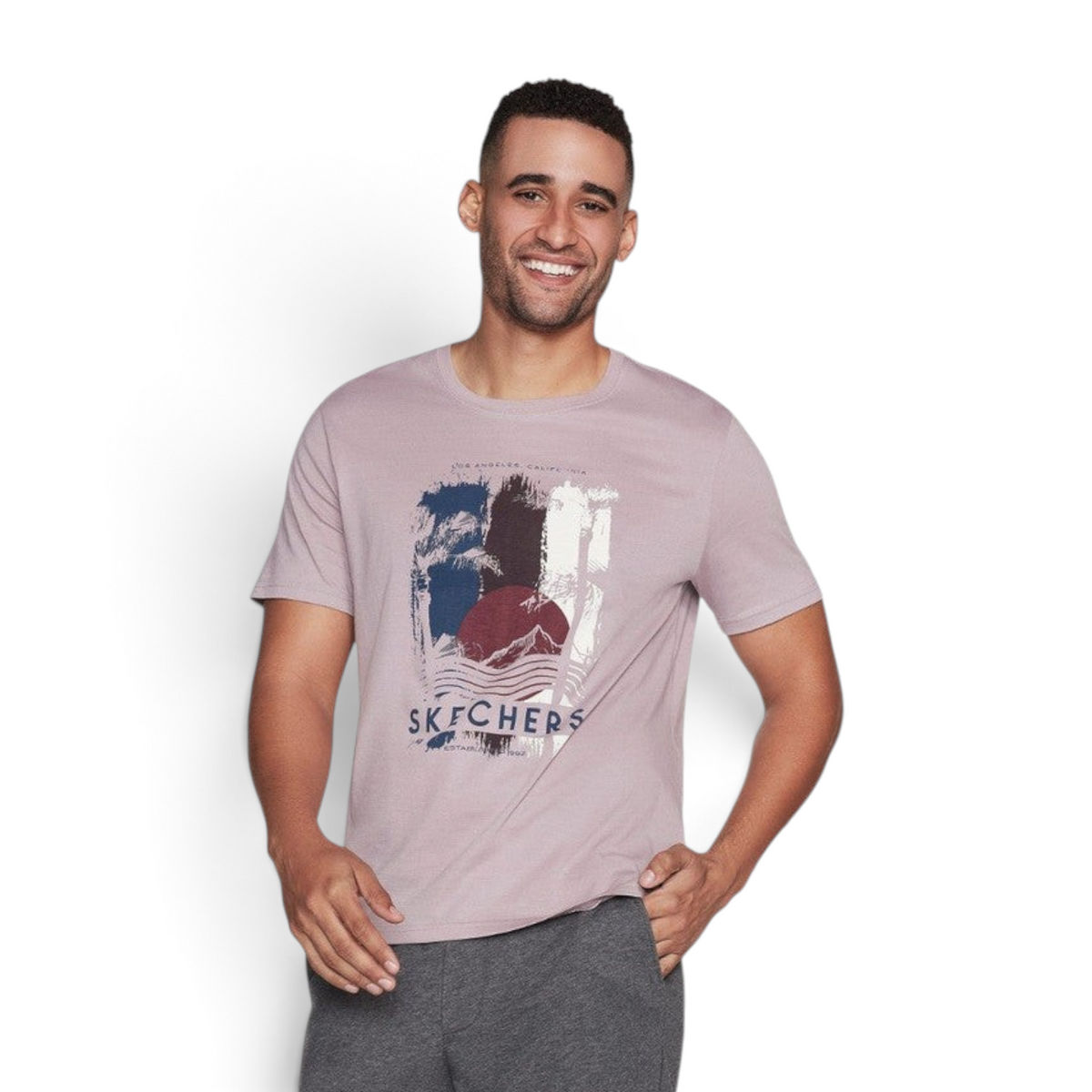 FRG Skechers Endeavour crewneck tee in taupe lavender with a graphic print worn by a smiling man
